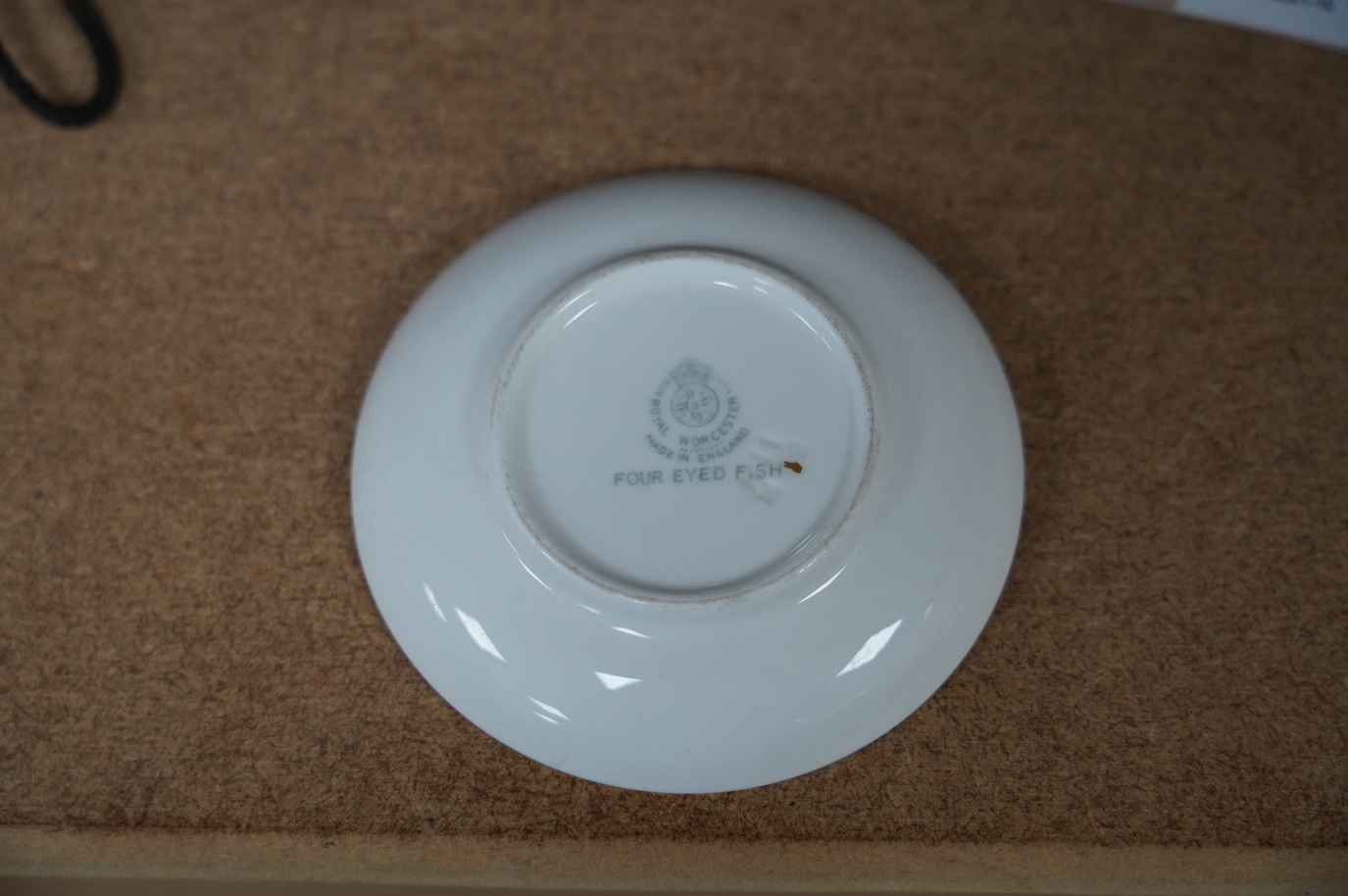 A Royal Worcester 'Four Eyed Fish' dish, signed, 9cm diameter. Condition - good